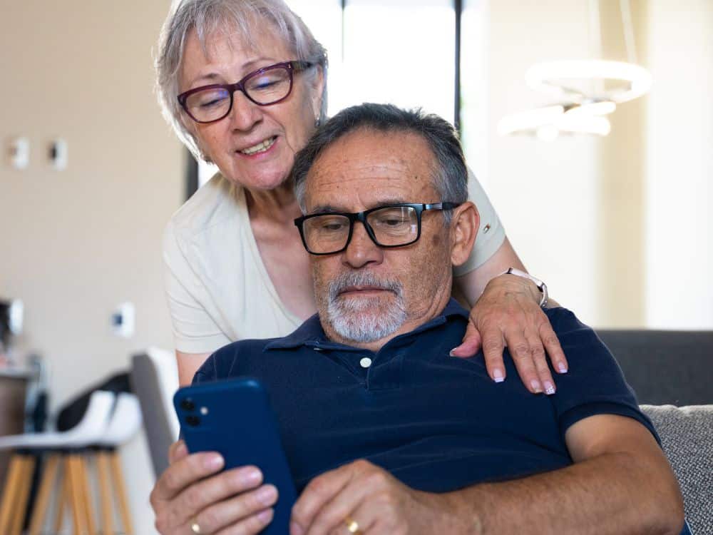 senior couple looking at phone together